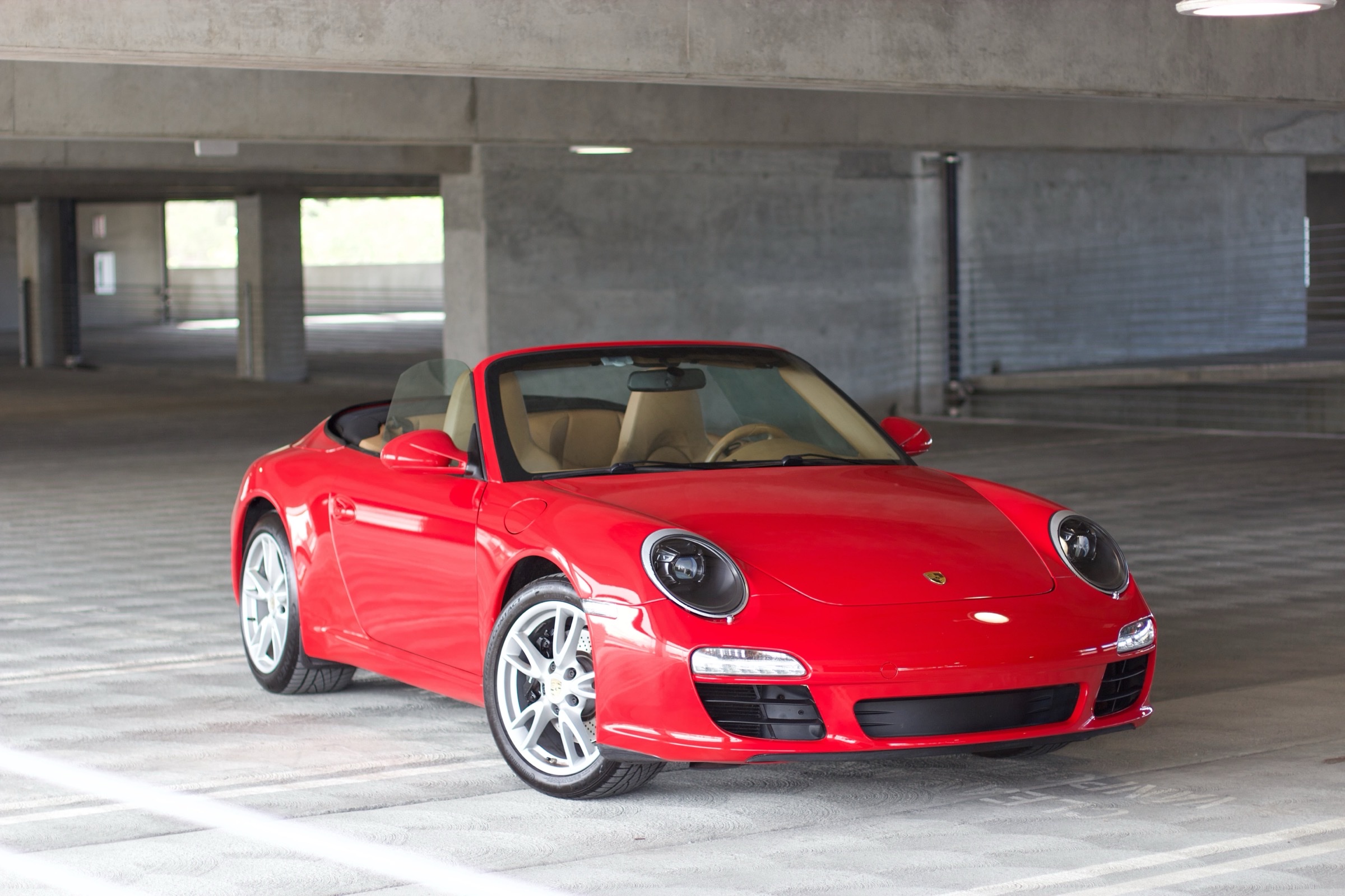 2010 Porsche 911 Carrera Cabriolet, Guards Red, front three-quarter view in parking garage