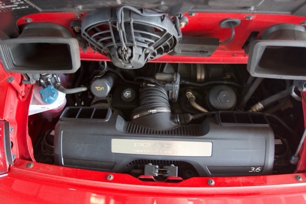 Wider engine bay view showing 3.6L badge
